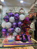 Lavender  Celebration Hamper (Includes  Balloon Decor ,Rose Bouquet ,Lights ,1/2 kg cake ,2 silk chocolate , 2 kit kat and one small perfume)