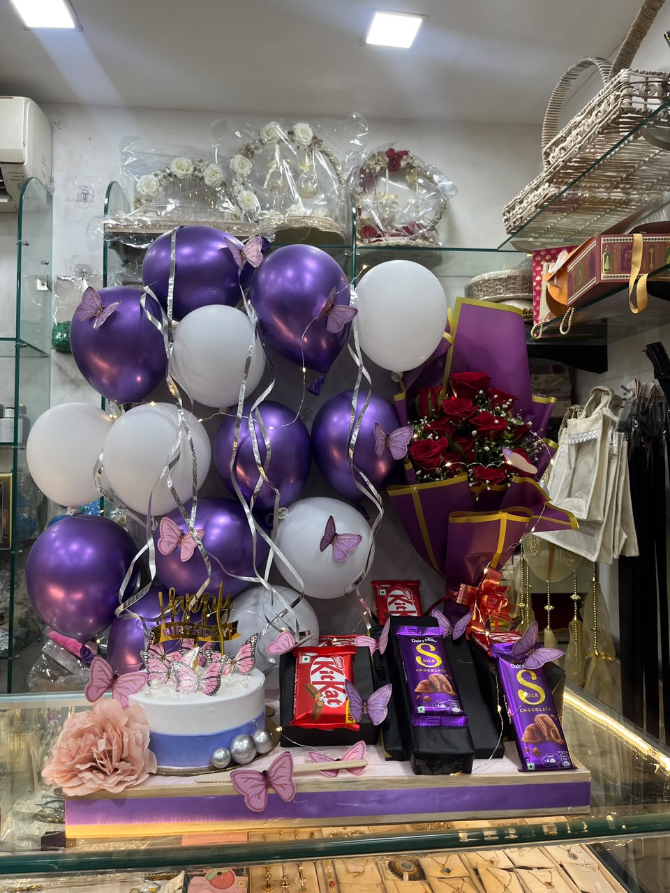 Lavender  Celebration Hamper (Includes  Balloon Decor ,Rose Bouquet ,Lights ,1/2 kg cake ,2 silk chocolate , 2 kit kat and one small perfume)