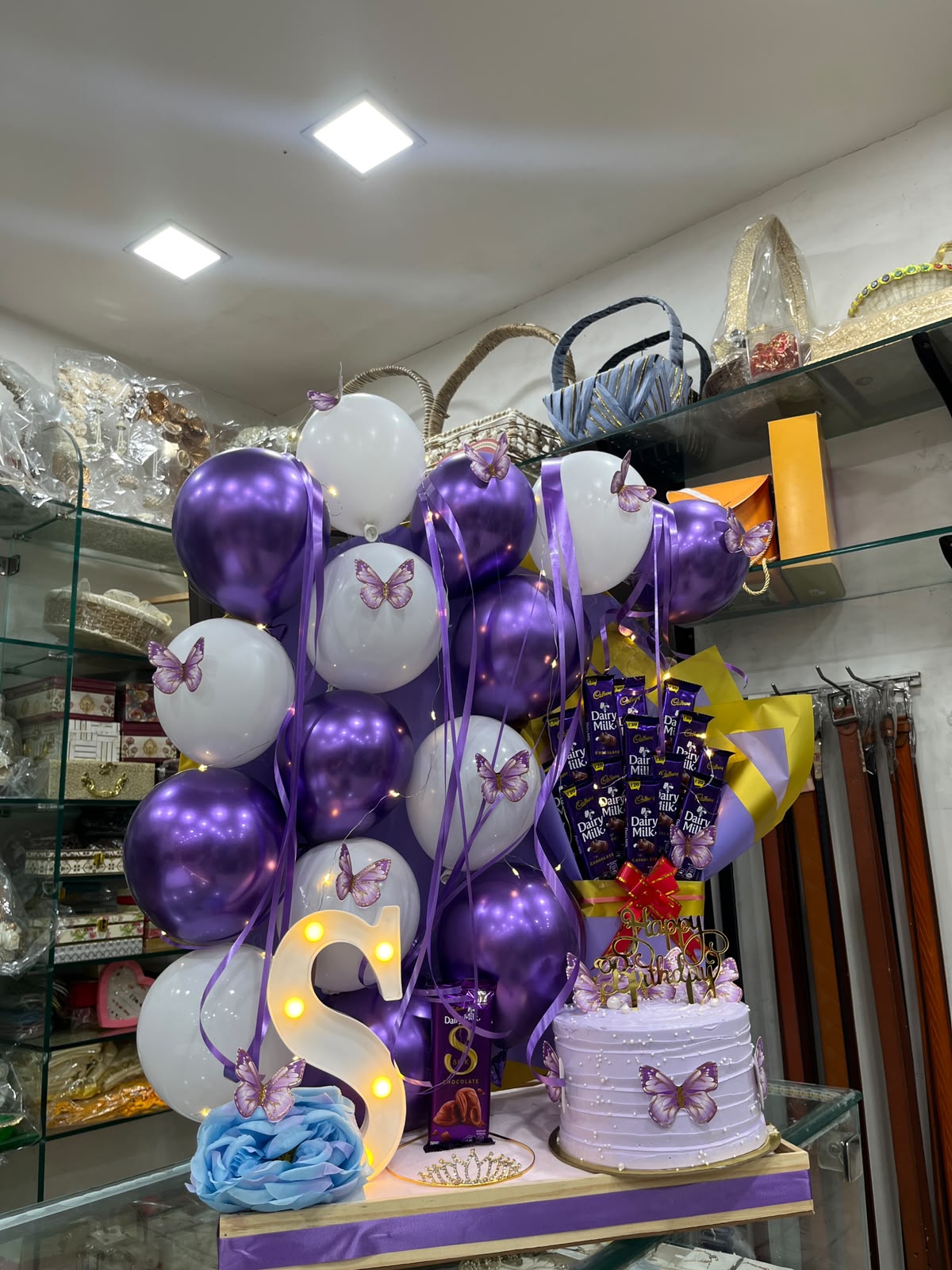Purple Butterfly Celebration Hamper(Includes Chocolates Bouquet ,Balloon decor, cake Initial Letter , Crown)