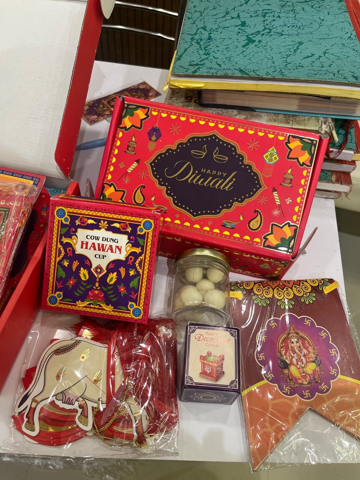 Diwali Box hamper 1 (Happy Diwali banner, Paper lotus wall art(1 pack of 2 pieces ), cow dung hawan cup(1 pack of 5 pieces), traditional aangan deep candle(1 unit), Coconut laddu(1 pack of 50gm)